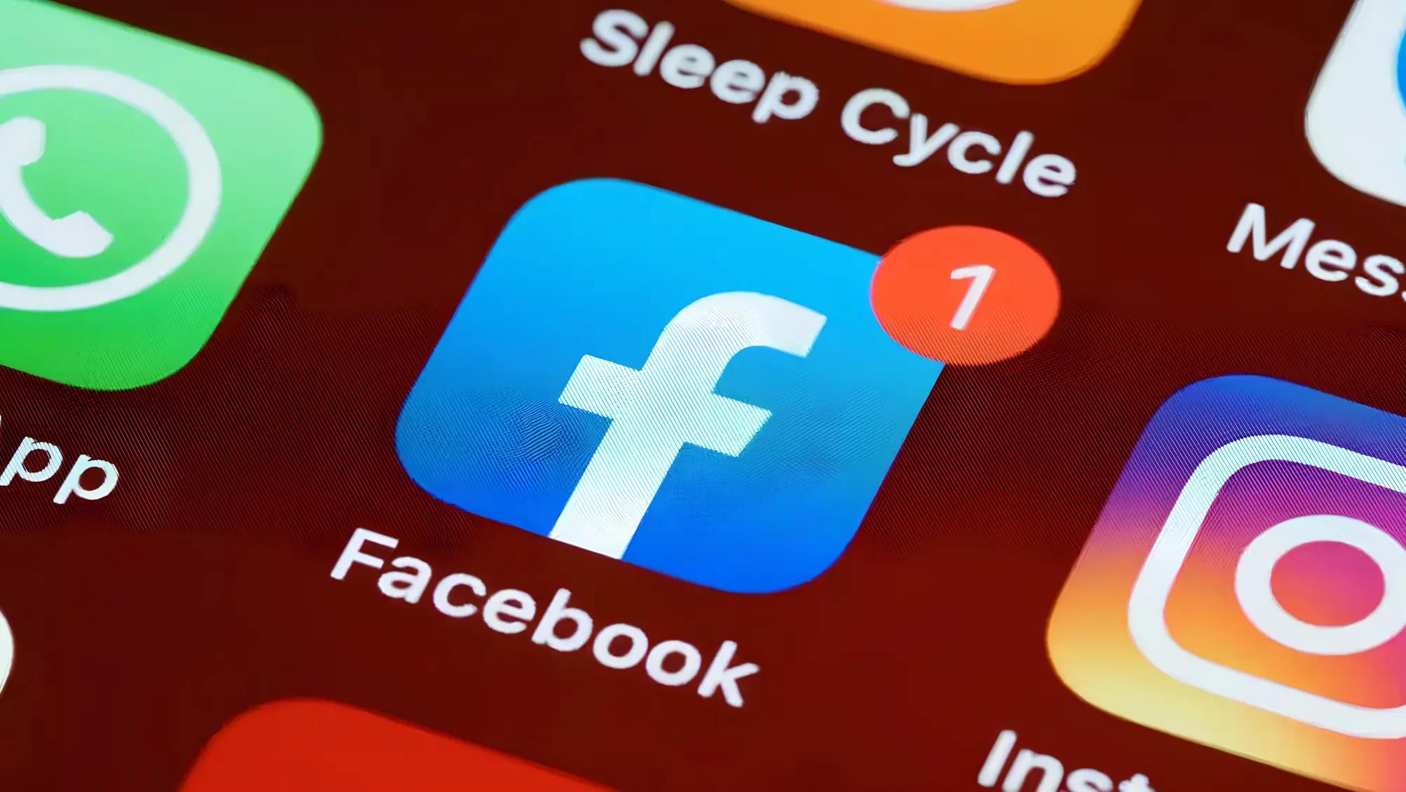 Facebook and Instagram logos displayed on a smartphone during a service outage affecting users across multiple regions.