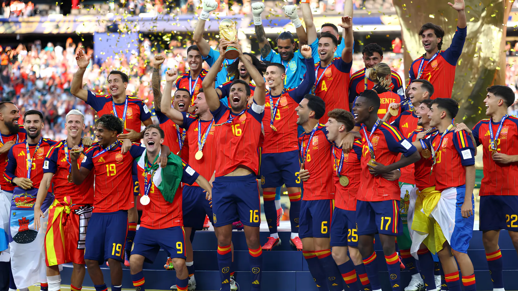 Spain football players celebrate with the FIFA World Cup trophy after defeating Argentina in the 2026 World Cup final.