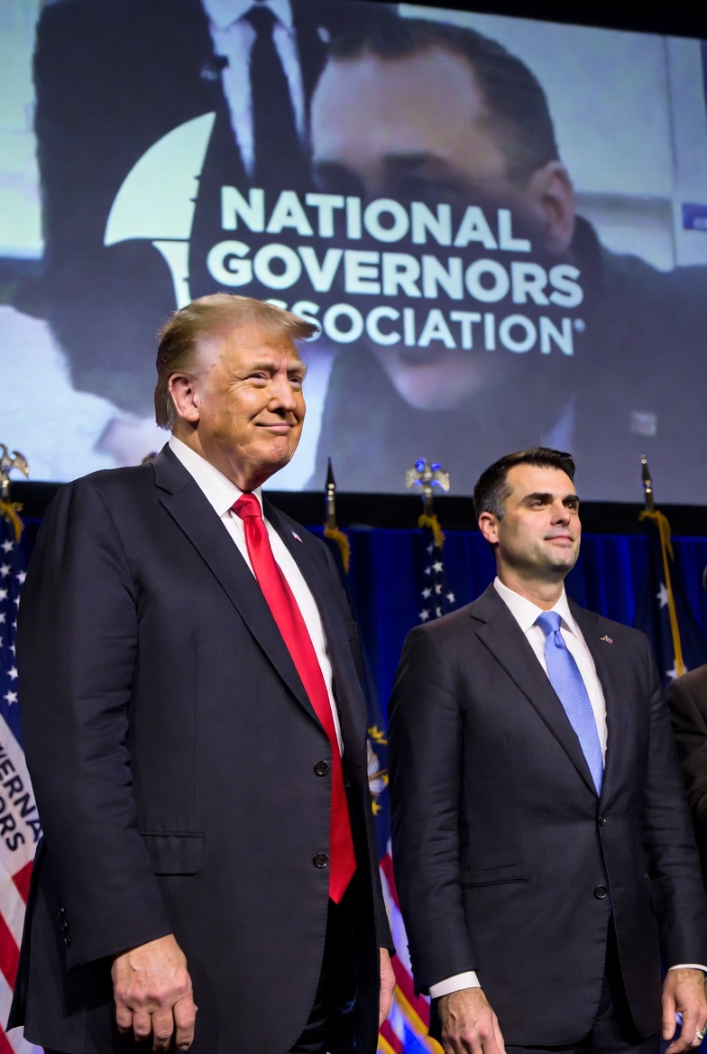 "President Donald Trump seated next to Oklahoma Governor Kevin Stitt during a White House meeting with governors, highlighting the recent Trump apology to Oklahoma over endorsing the 'mediocre' Republican governor amid NGA tensions."