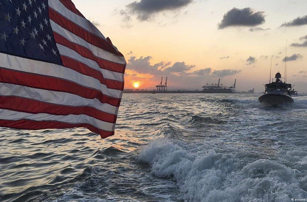 U.S. Navy vessel monitoring an oil tanker in a high-tension maritime zone