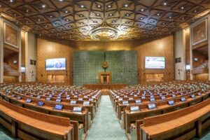 Indian Parliament building with electoral constituency map overlay representing delimitation debate