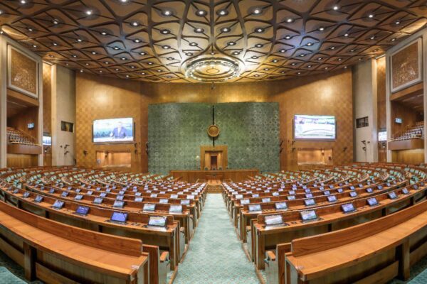 Indian Parliament building with electoral constituency map overlay representing delimitation debate