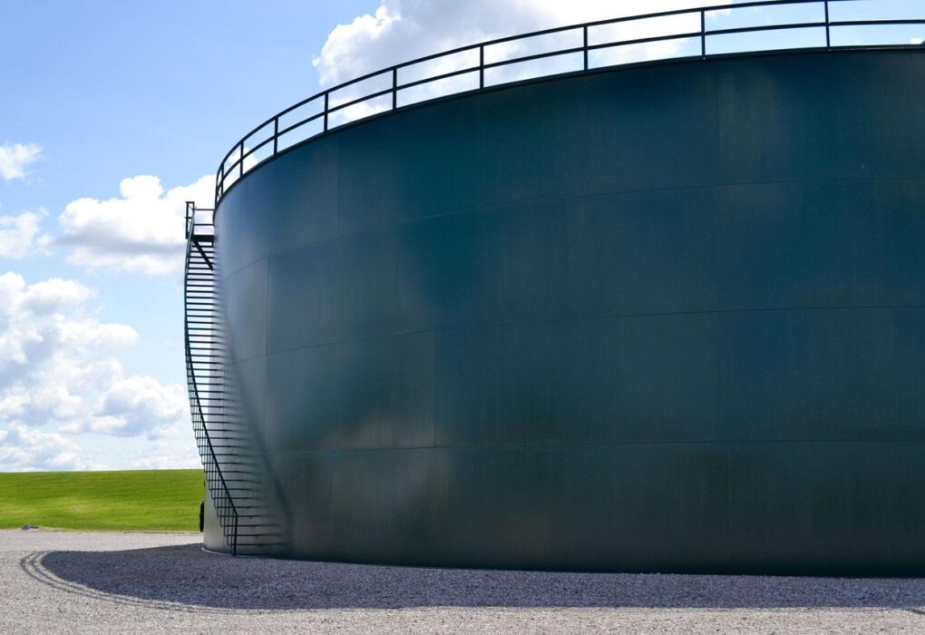 Cargo ships and fertiliser storage facilities representing the global food supply risks caused by disruptions from the Iran conflict.