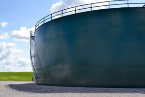 Cargo ships and fertiliser storage facilities representing the global food supply risks caused by disruptions from the Iran conflict.